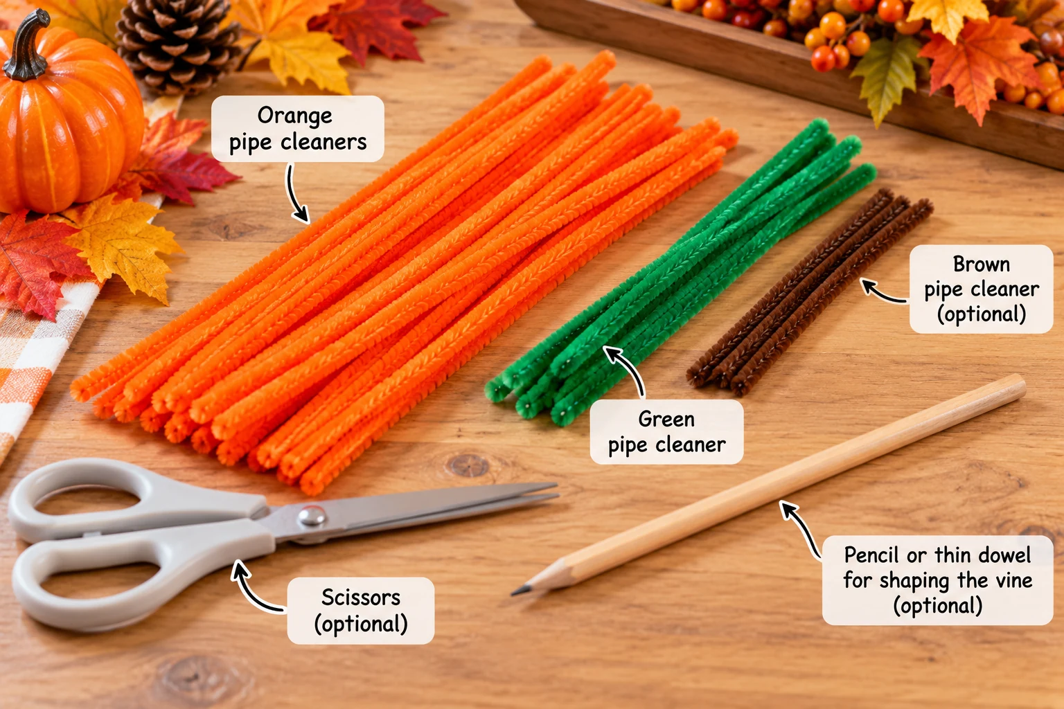 Orange, green and optional brown pipe cleaners with scissors and a pencil on a craft table
